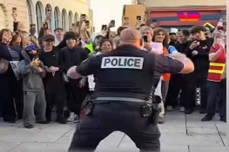 In Francia, un Poliziotto e Studenti in una ‘Battle d’Aura’: Un Momento di Tensione e Umorismo